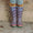 Muddy Puddles boots with a lightning bolt pattern, worn by a child with colourful socks and leggings, standing on a stone surface.