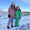Muddy Puddles waterproofs: Two kids in snow. Girl in lightning bolt pattern, boy in green, mountainous backdrop.