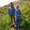Our Collections. Two young girls hold hands amidst a grassy meadow, sporting vibrant, checkered outerwear and wellington boots.