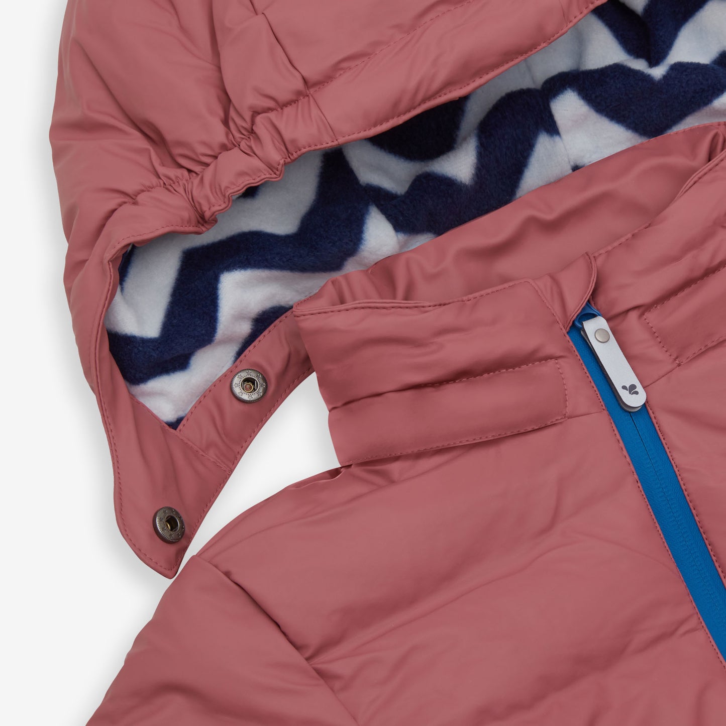 Close-up of a pink waterproof puffer jacket with a blue zipper. The hood has a blue and white chevron patterned lining.