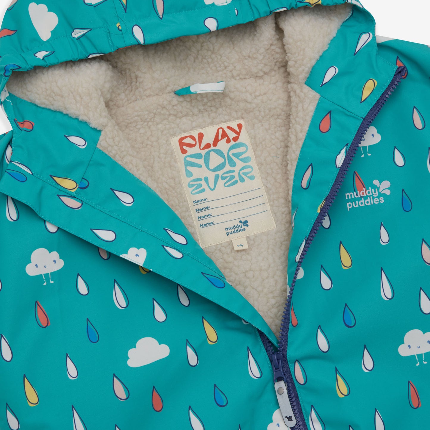 A Muddy Puddles Waterproof Changing Robe Green Raindrops showing the inner lining and a label with space for a name.