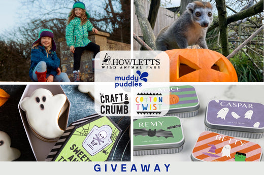 Children in waterproof outdoor clothing, Halloween treats, and animal-themed giveaway prizes.