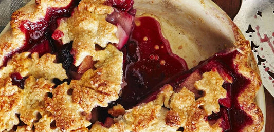close up of blackberry and apple pie with leaf shaped pastry decoration