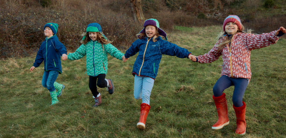 Children in woodland wearing Muddy Puddles waterproof