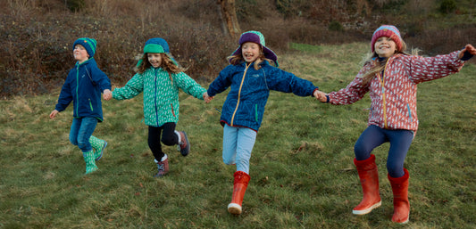 Children in woodland wearing Muddy Puddles waterproof