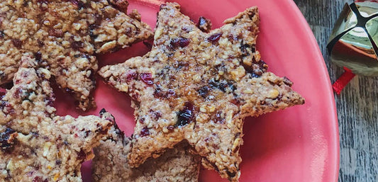 star shaped orange and cranberry cookies on a pink plate