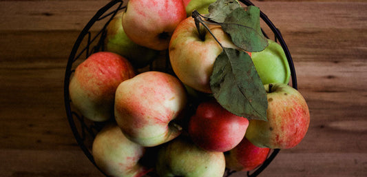 bowl of apples on wooden surface