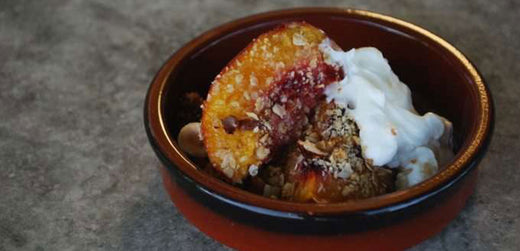 roasted nectarines and yoghurt in a brown dish