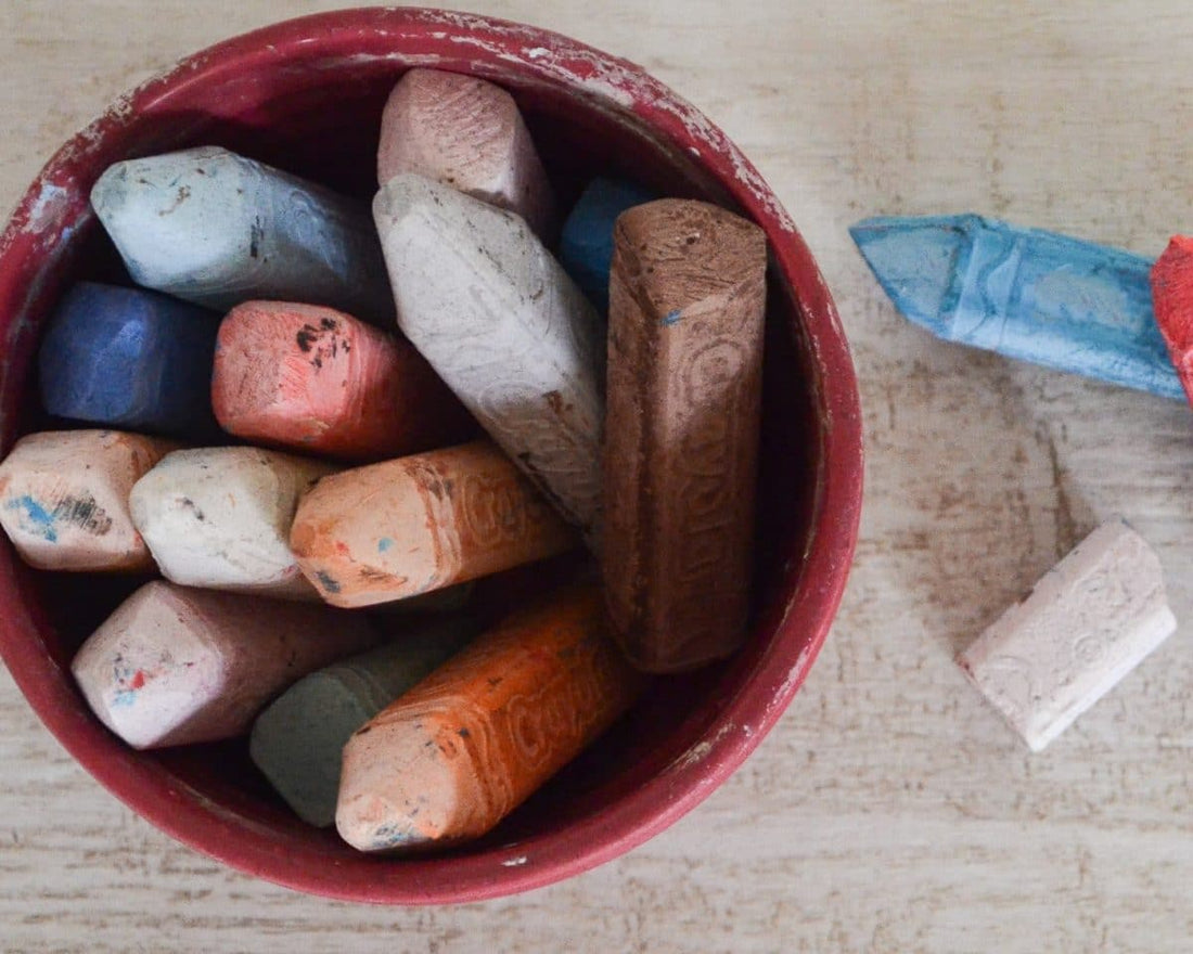 close up of coloured chalk in a red cup