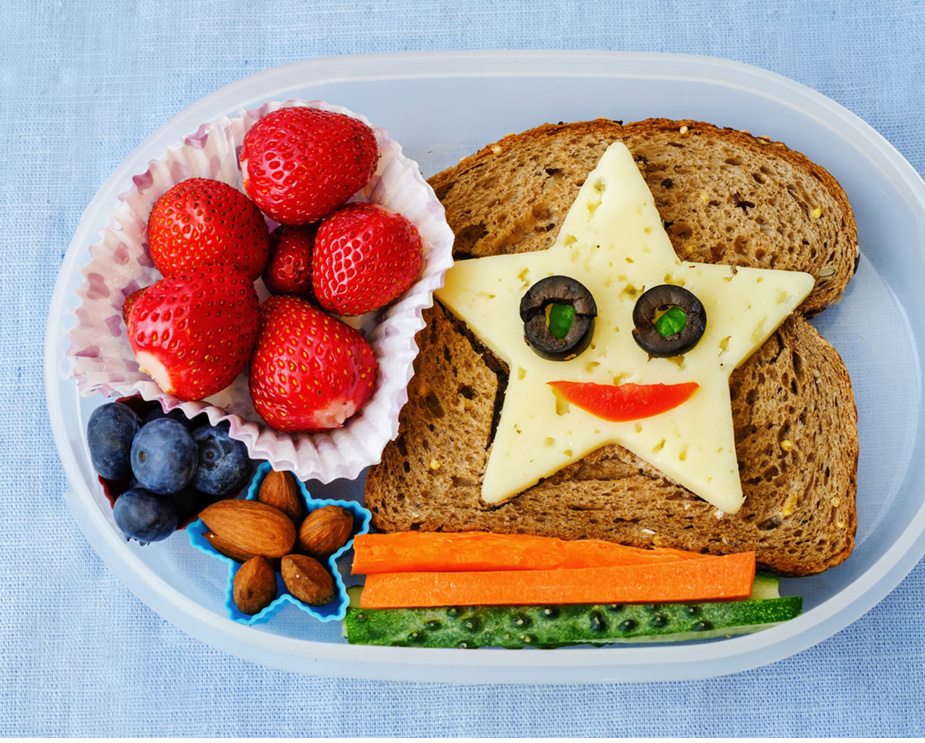 childs lunchbox with healthy snacks and star shaped sandwich filler
