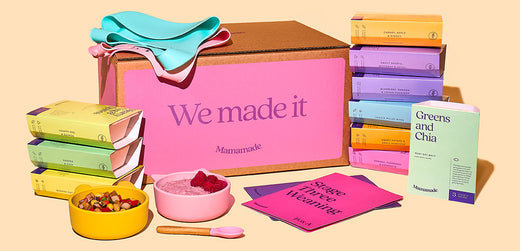 Colorful meal kit with boxes, bibs, and bowls of healthy food for children on pastel background