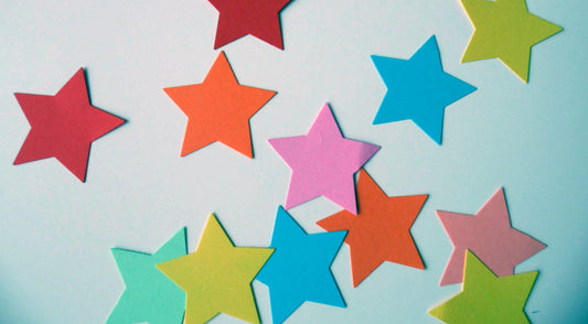 colourful star shaped post-it notes on a white background