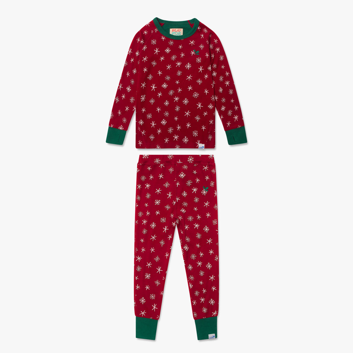 Kids Pyjamas Red Christmas: A durable two-piece set featuring festive snowflakes and starbursts, with green cuffs and embroidered sprigs, perfect for cozy winter nights.