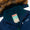 Waterproof Parka Navy featuring a navy-blue shell, faux-fur-trimmed hood, teal fleece lining, and a PLAY FOREVER label for name personalization.