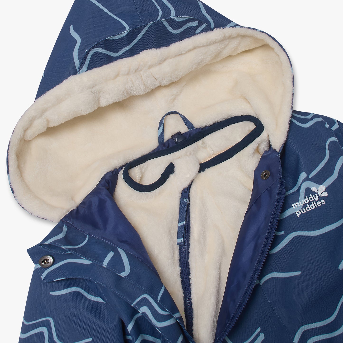 3 in 1 Waterproof Scampsuit Blue Mountains: Durable children’s snowsuit top with cream sherpa lining, featuring a navy and light-blue wavy pattern, by Muddy Puddles.