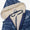 3 in 1 Waterproof Scampsuit Blue Mountains: Durable children’s snowsuit top with cream sherpa lining, featuring a navy and light-blue wavy pattern, by Muddy Puddles.