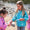 Two girls looking at fish on the beach while wearing the EcoLight Lightweight Waterproof Jacket Green Raindrops.