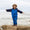 Toddler balances on rock in a Waterproof Softshell Puddle Suit Blue, showcasing its durable, waterproof design ideal for adventurous play in wet conditions.