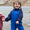 Toddler smiling by water in a durable Waterproof Softshell Puddle Suit Blue, holding hands with another child. Ideal for adventurous, weatherproof play.