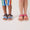 Two children wear Trekker Kids Sandals Pink, featuring durable, adjustable straps for secure fit and comfort during outdoor adventures, ideal for mixed terrain exploration.