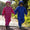 Two toddlers in Essentials Waterproof Puddle Suits Blue Raindrop explore a garden path, showcasing the durable, waterproof design ideal for rainy outdoor adventures.